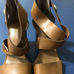 Tan crisscross top with  square heels. Open toed.